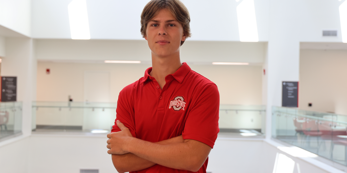Ryan Brown crosses arms in scarlet Ohio State shirt