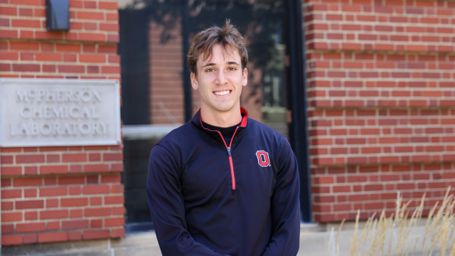 A person is standing in front of the McPherson Chemical Laboratory building.