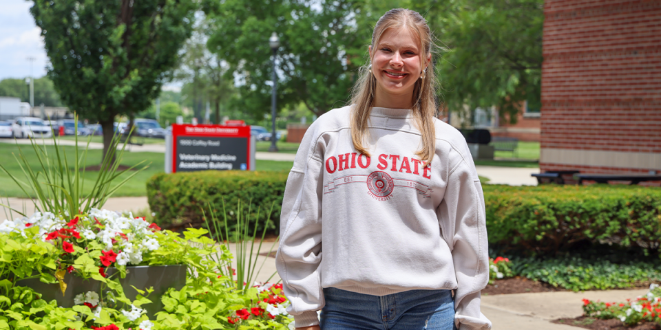 Kalyna Kulchytsky stands outside Vet Med Academic Building in gray Ohio State shirt.