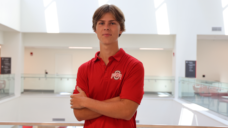 Ryan Brown crosses arms in scarlet Ohio State shirt